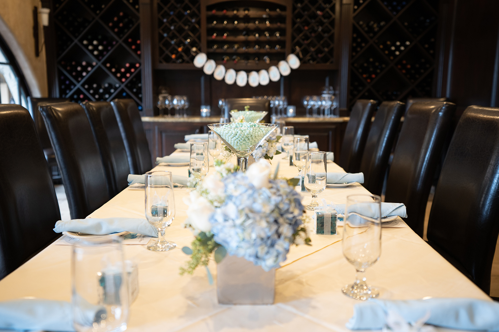 Boccaccio's private wine room with a banquet table with floral center pieces set up for a private event